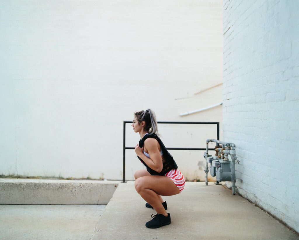 Woman working out outdoors with weighted vest