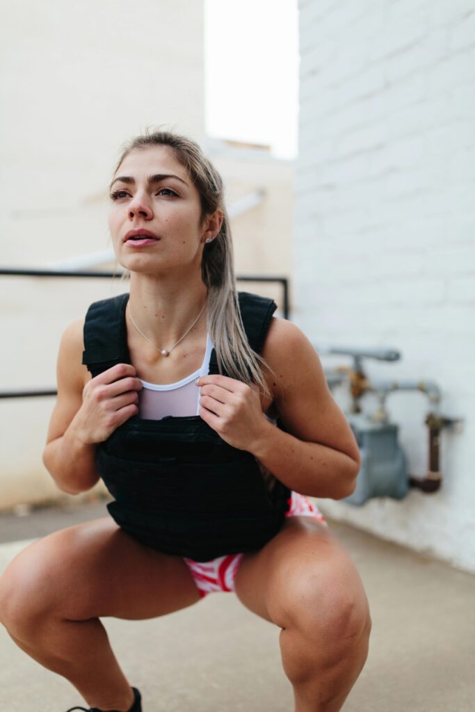 Woman working out with a black weighted vest